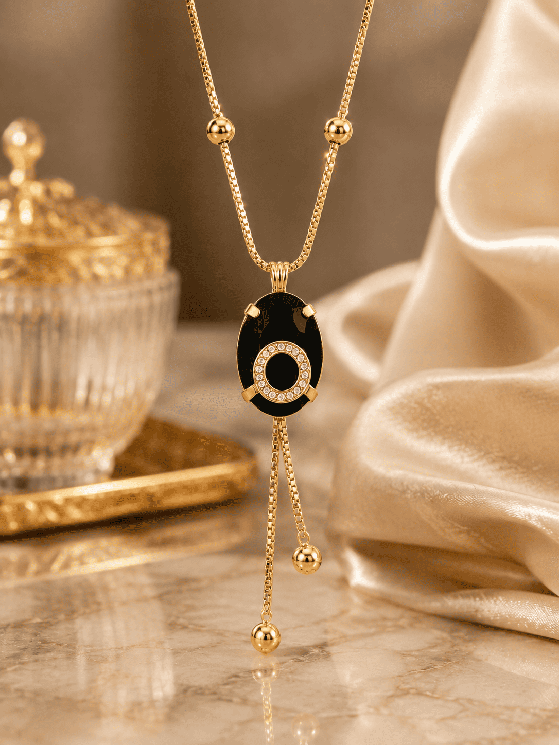 Gold-Tone Black Oval Pendant Necklace with Crystal Halo